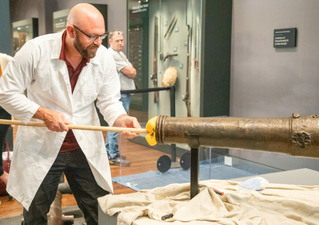 Texas A&M anthropologist and nautical archaeologist Chris Dostal swabbing the bore of the Alamo cannon