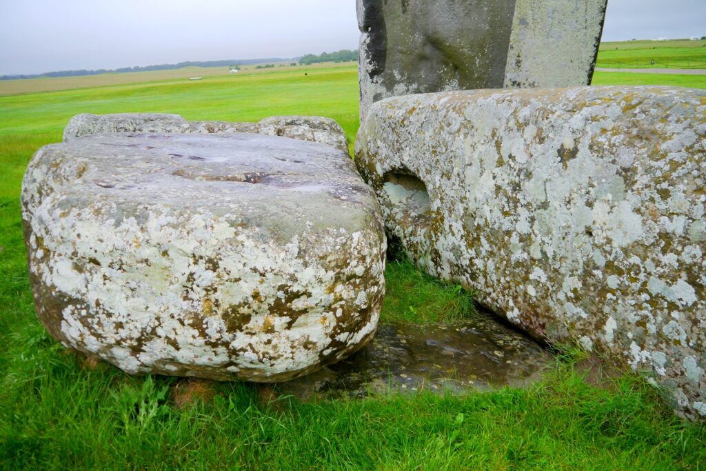 The Altar Stone beneath two bigger sarsen stones