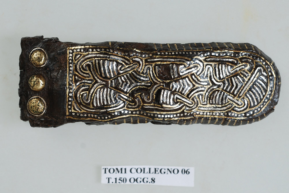 Iron end element of belt for weapon suspension with silver and brass inlay from a tomb in Collegno, Italy