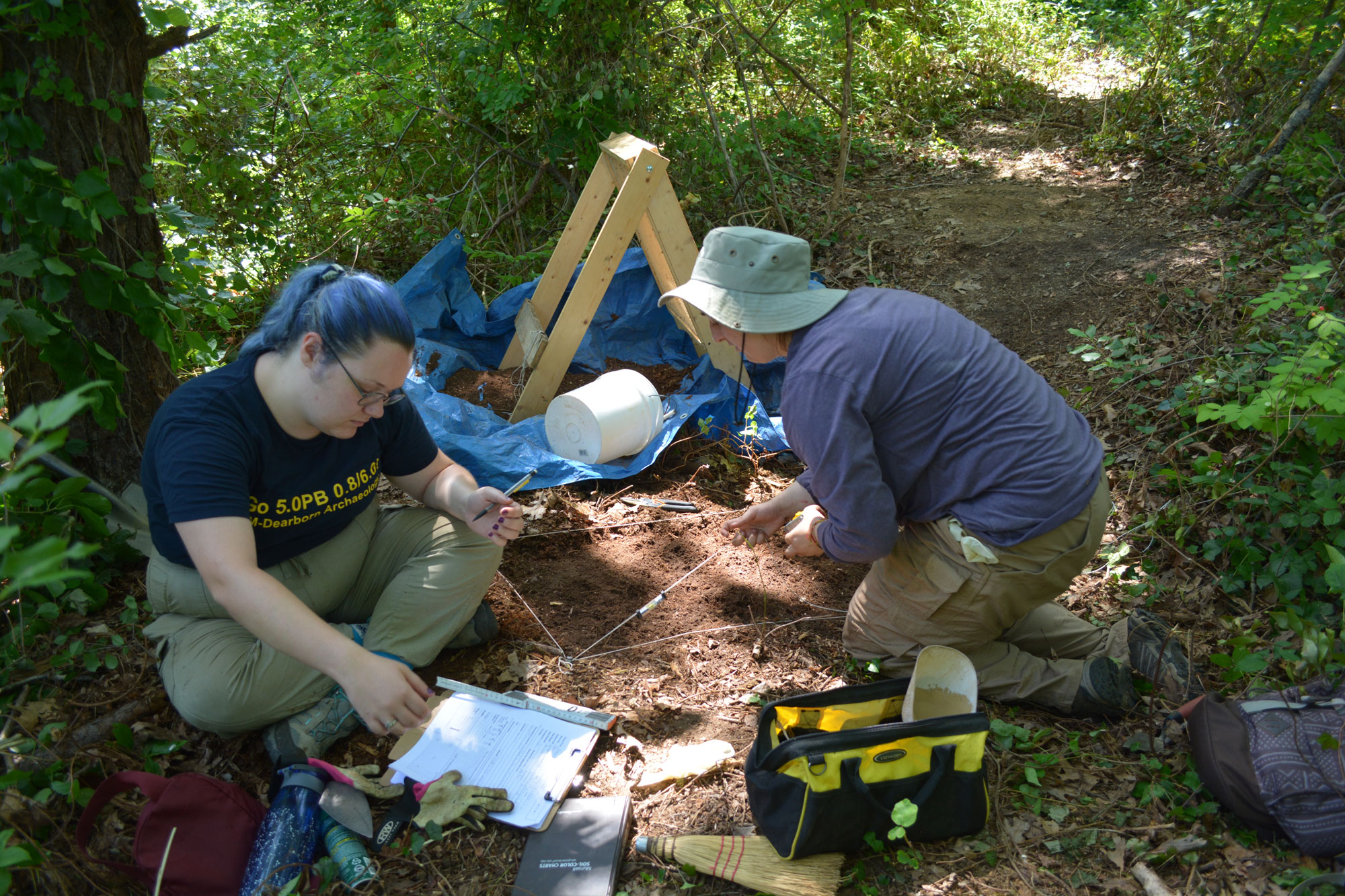 Students record a layer of a test unit at the site of the home of John Doane in Eastham, Massachusetts