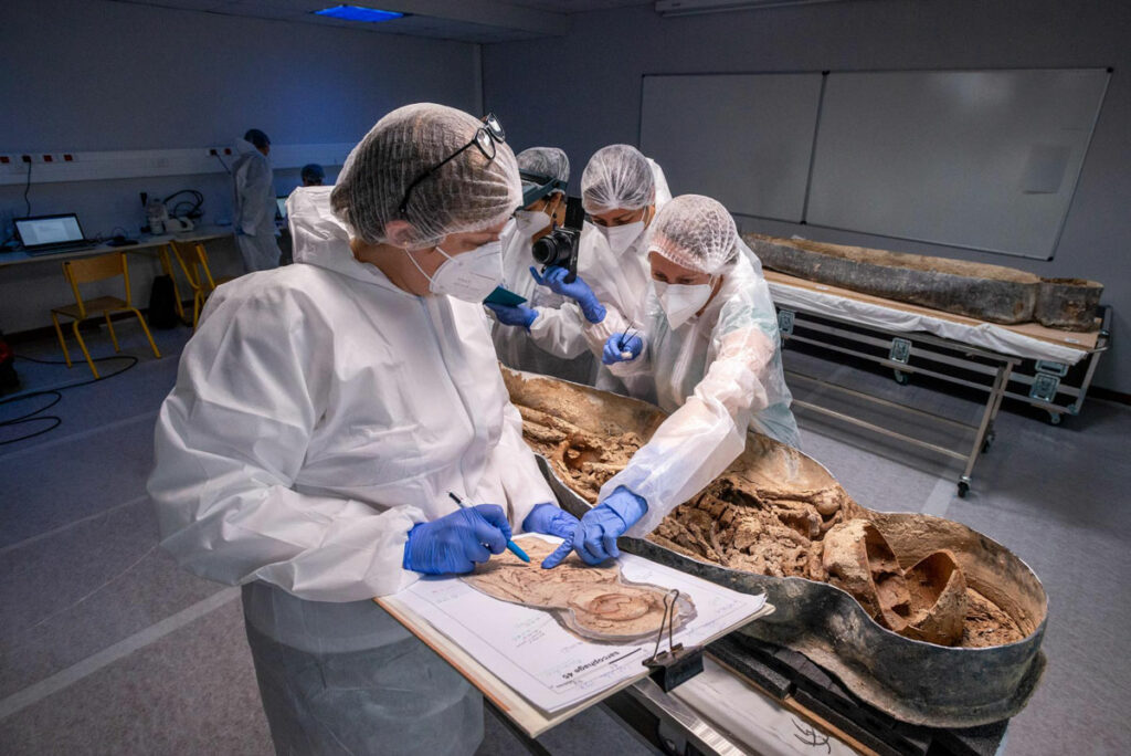 Scientists study the sarcophagus and skeleton of the man now believed to be Joachim du Bellay