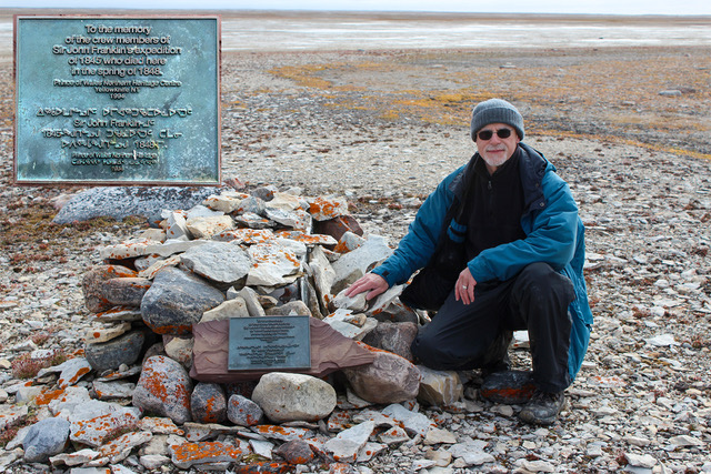 Douglas Stenton at commemorative cairn at NgLj-2 where the remains of James Fitzjames and 12 other Franklin expedition sailors rest