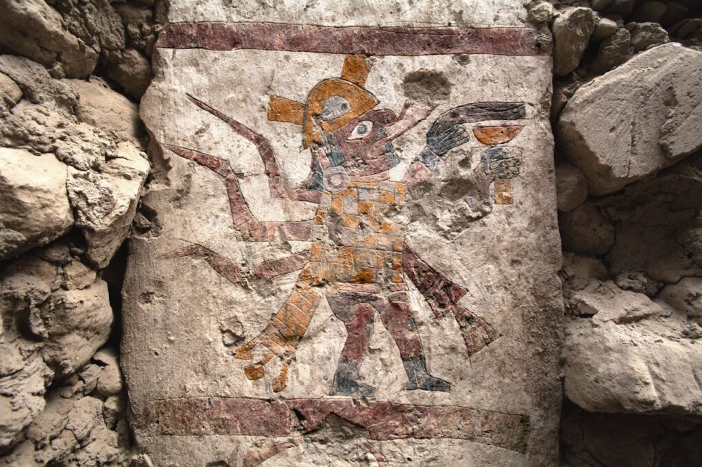 Painting depicting a Moche figure with human body and spider features on a pillar of the Hall of the Moche Imaginary, Pañamarca, Peru