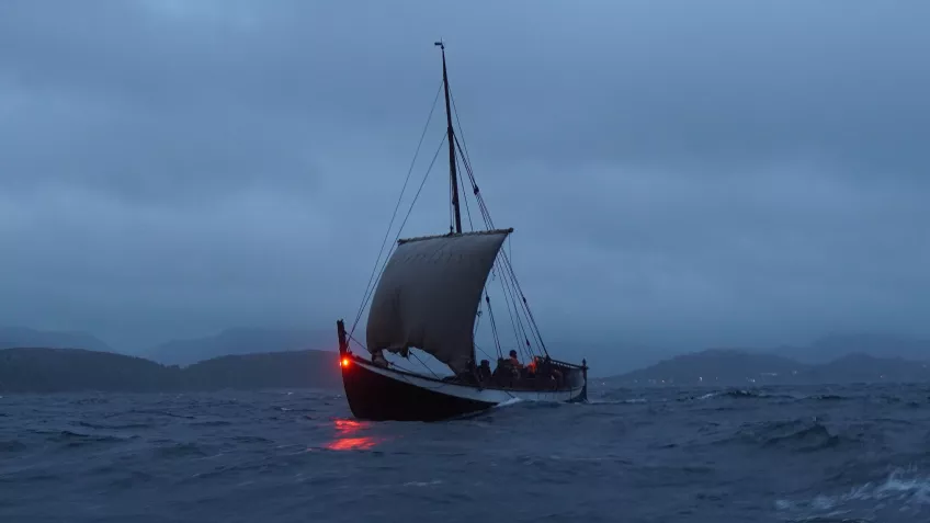 Sailing at night in one of the larger expeditionary vessels likely used by the Norse