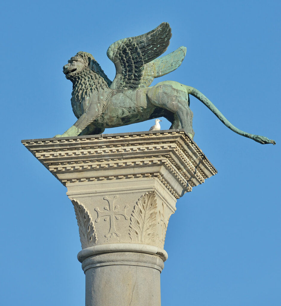 Bronze winged lion atop a column in St. Mark’s Square, Venice, Italy