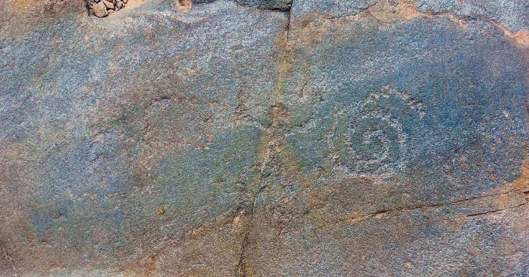 Engraved human figure in so-called praying position and spiral glyph, Stelvio National Park, Lombardy, Italy