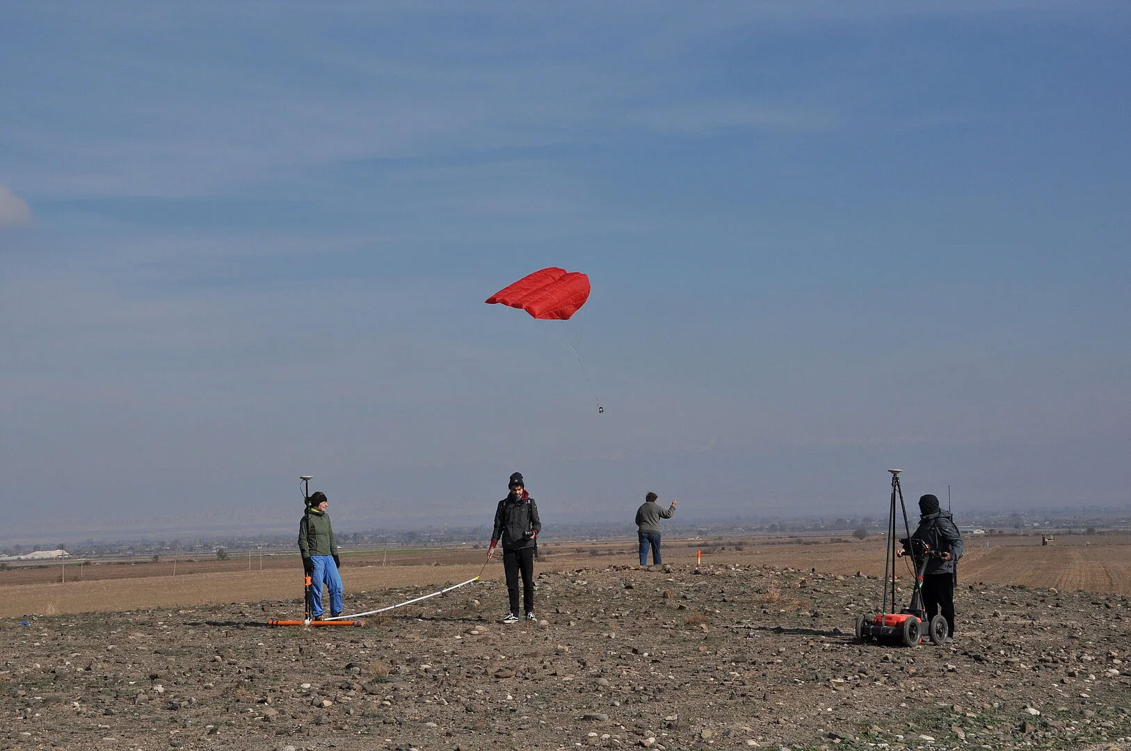 Researchers document and investigate a kurgan with a ground penetrating radar (right), an electromagnetic probe (left) and a camera attached to a kite