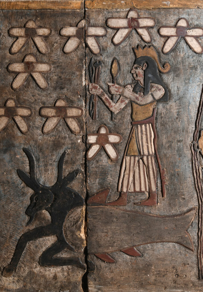 An image of a weapon-wielding war god representing the planet Mars stands atop the fish-tailed goat Capricorn