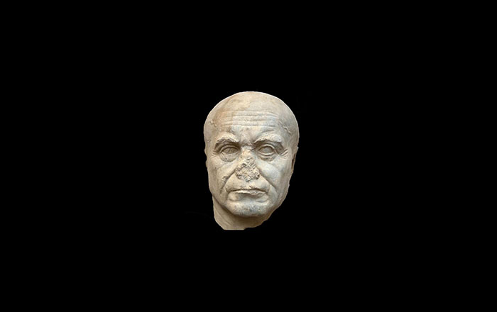 Marble statue head depicting an elderly man from Taposiris Magna, Egypt