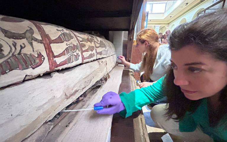 Researchers studying one of the coffins at the Egyptian Museum in Cairo