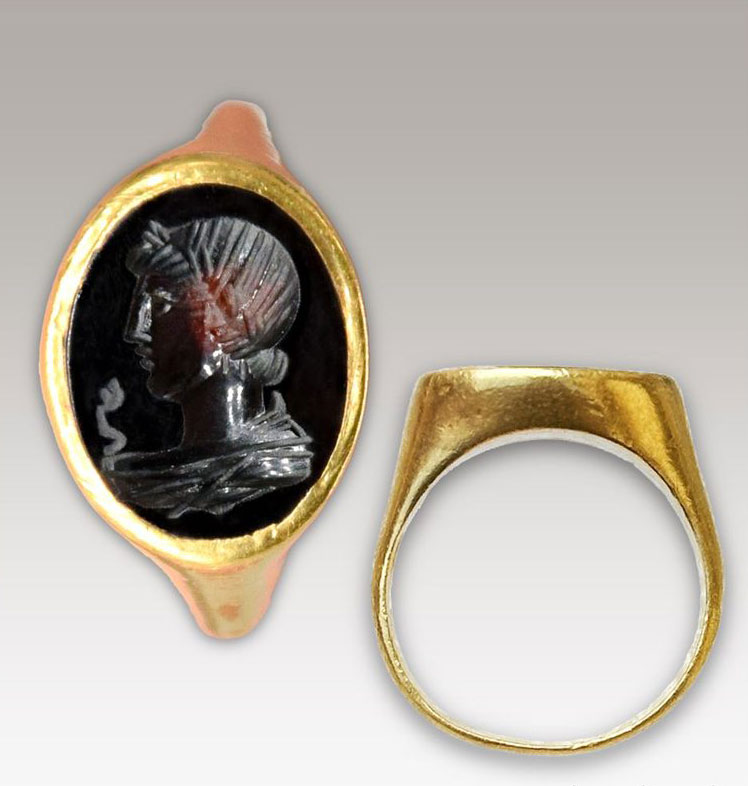 Gold ring inlaid with semiprecious stone carved with an image of Apollo and two serpents