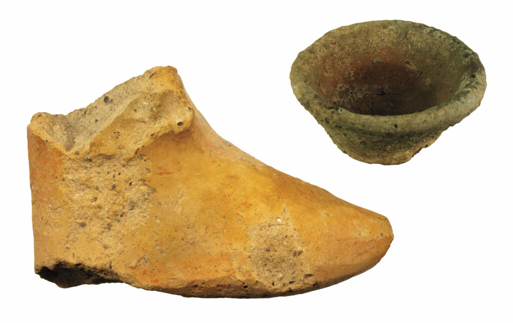 Miniature pottery vessel and terracotta foot that belonged to the statue of a god