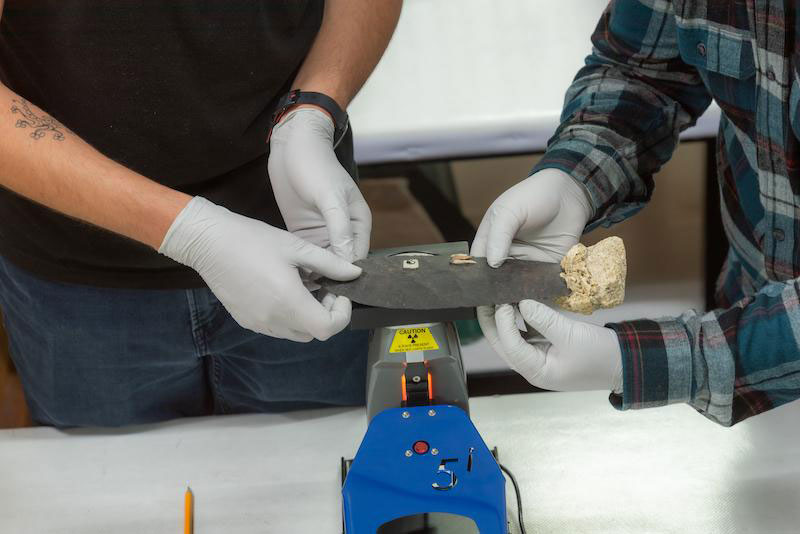 Researchers analyze an obsidian artifact