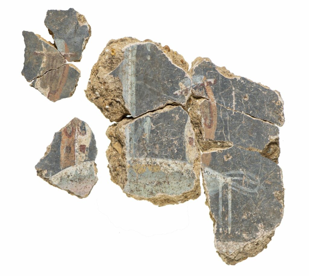 Plaster painted with depictions of lyres