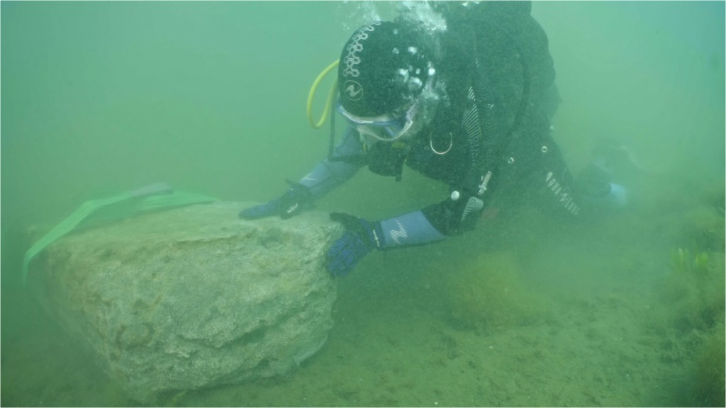 A diver recovers a Roman marble block from the seafloor.