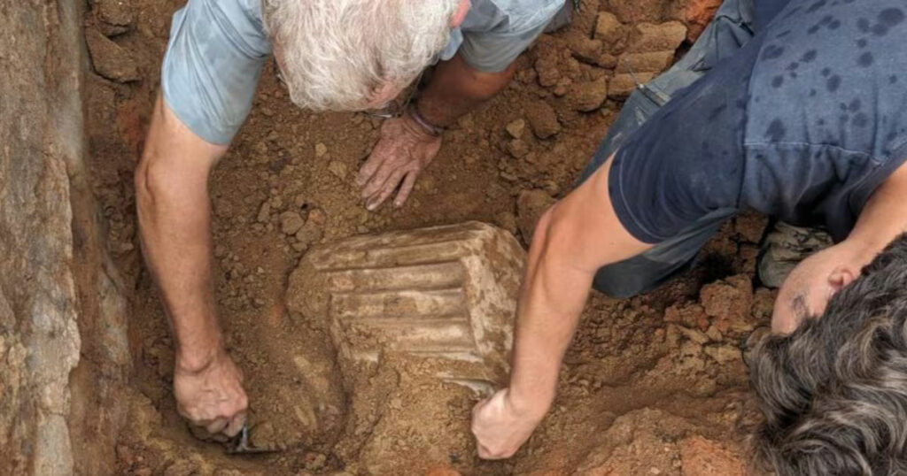 Archaeologists uncover the marble column fragment at Casas del Turunuelo, Spain.