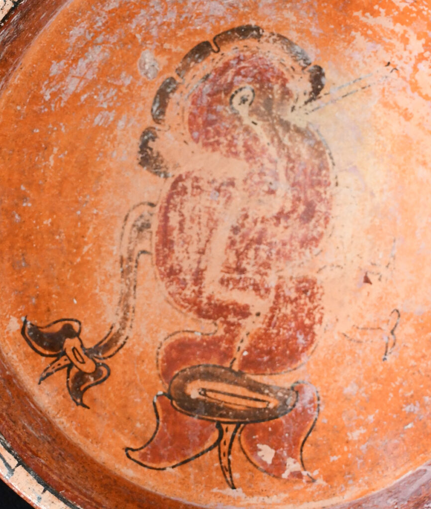 Interior of ceramic vessel painted with an image of a hummingbird