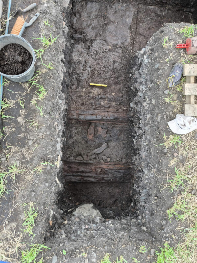 Excavation trench with remnants of wooden structures, Kringkastingsjordet, Norway
