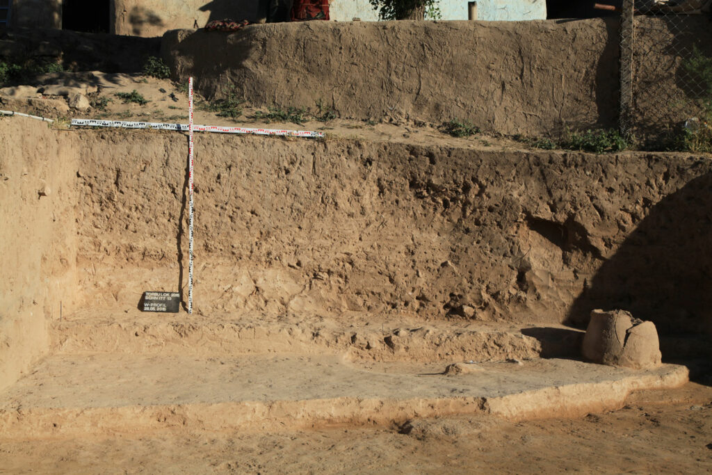 Excavation trench showing water basin (left) and upside down sunken storage jar (right)