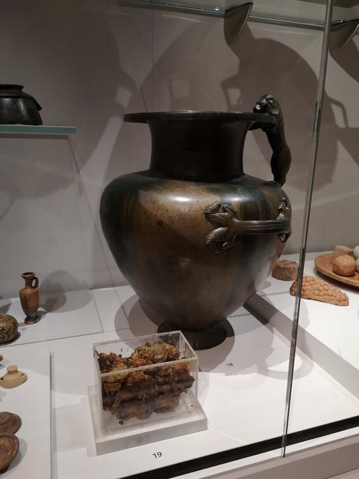 Bronze jar in the Ashmolean Museum with (foreground) the substance that was inside the vessel