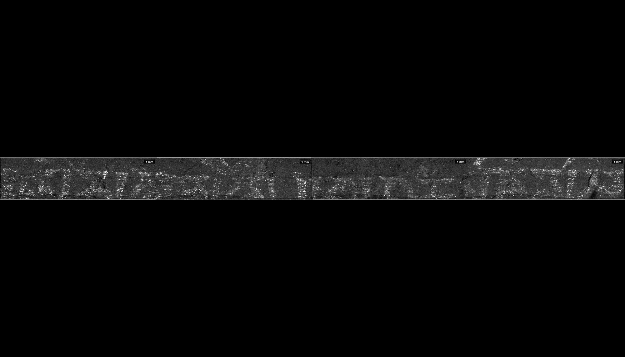 Strip of text on unrolled scroll that reads, Om mani padme hum
