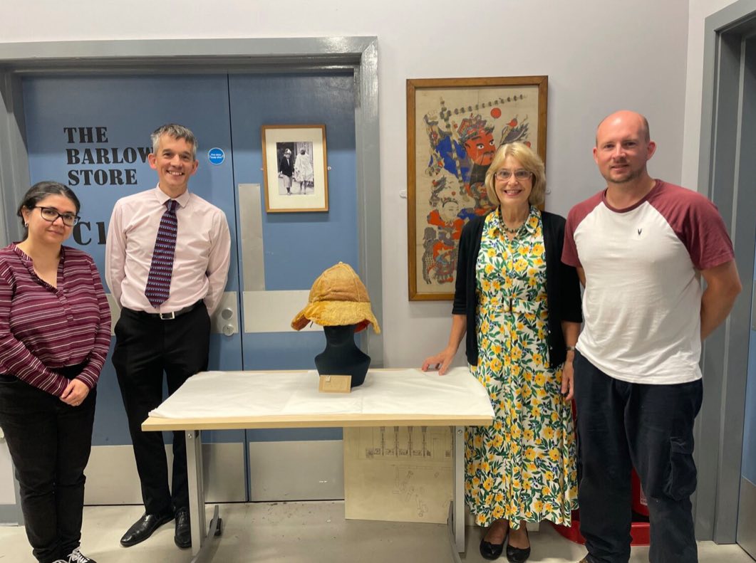 Bolton Museum staff pose with the conserved Roman sun hat