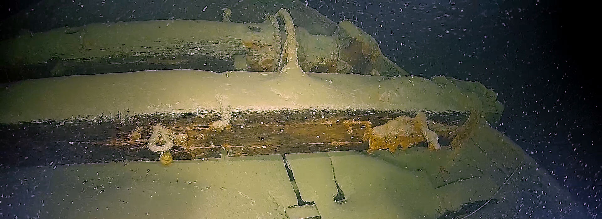 Sediment-covered deck of a fully preserved wooden cargo sailing ship on the bottom of Lake Constance, Germany