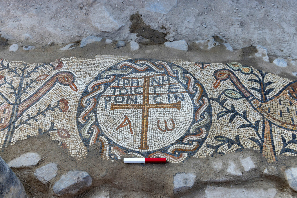 Mosaic inscription reading “Peace be with the elders"