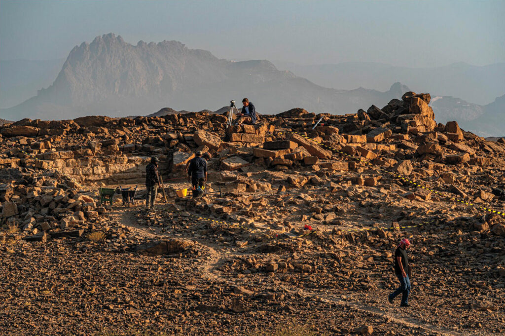Archaeologists excavate the ruins of an Umm an-Nar tower at the site of Bisya, Oman