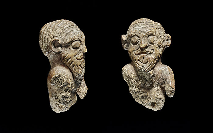 Side and front view of ivory gaming piece carved with a man's face