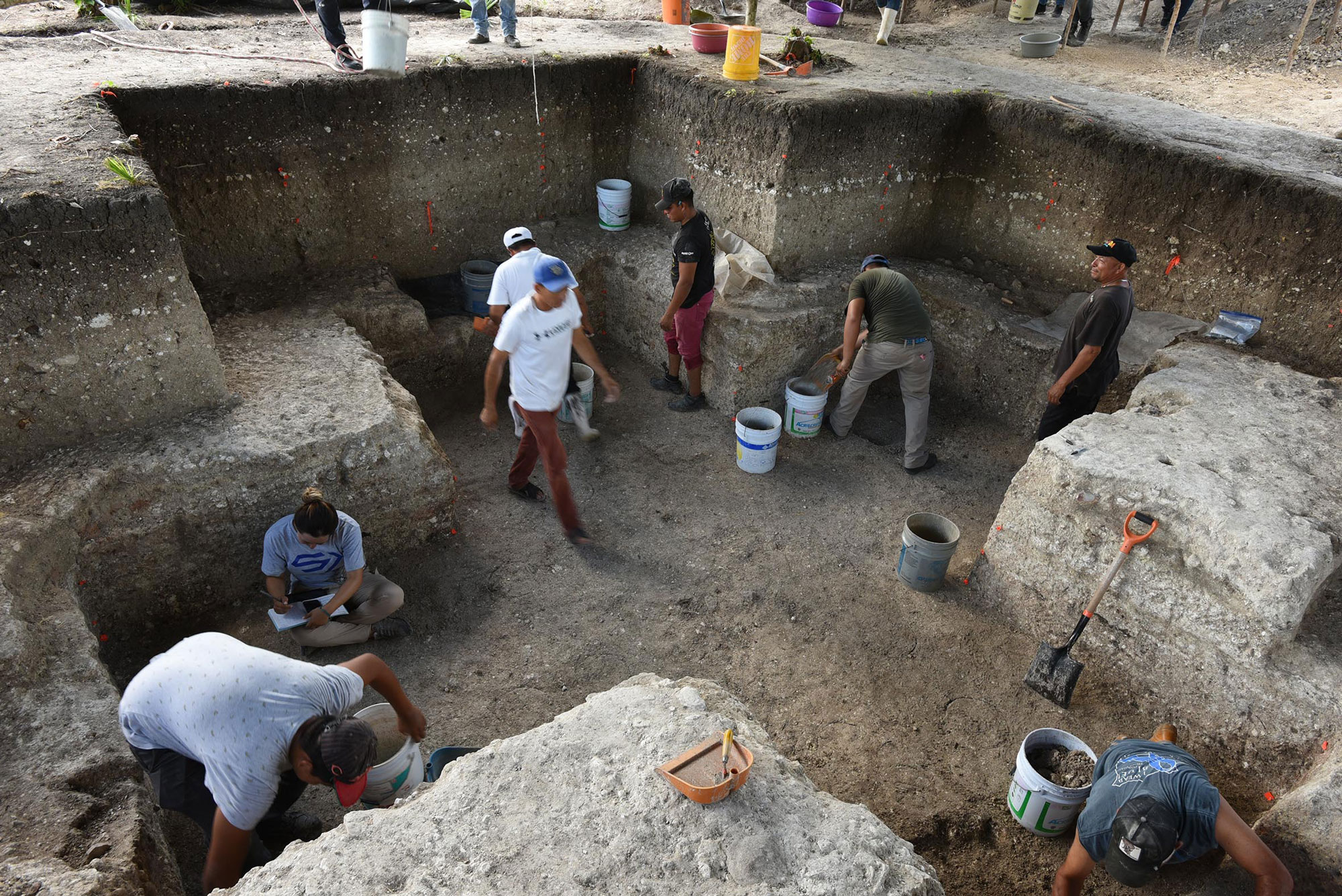 Archaeologists excavating the cruciform pit, Aguada Fénix, Mexico