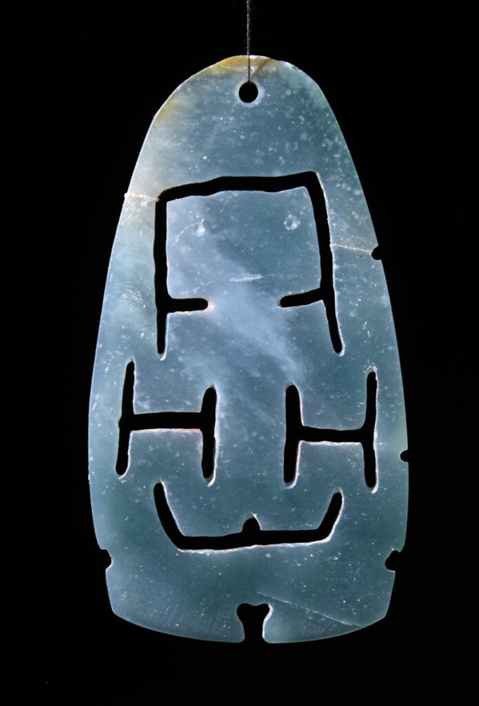 Jade artifact likely representing a woman giving birth