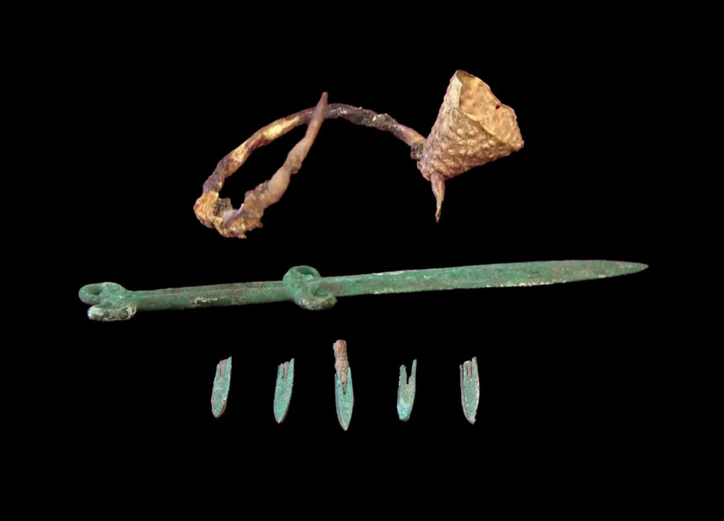 Top to bottom: Saka gold earring, sword, and metal arrowheads