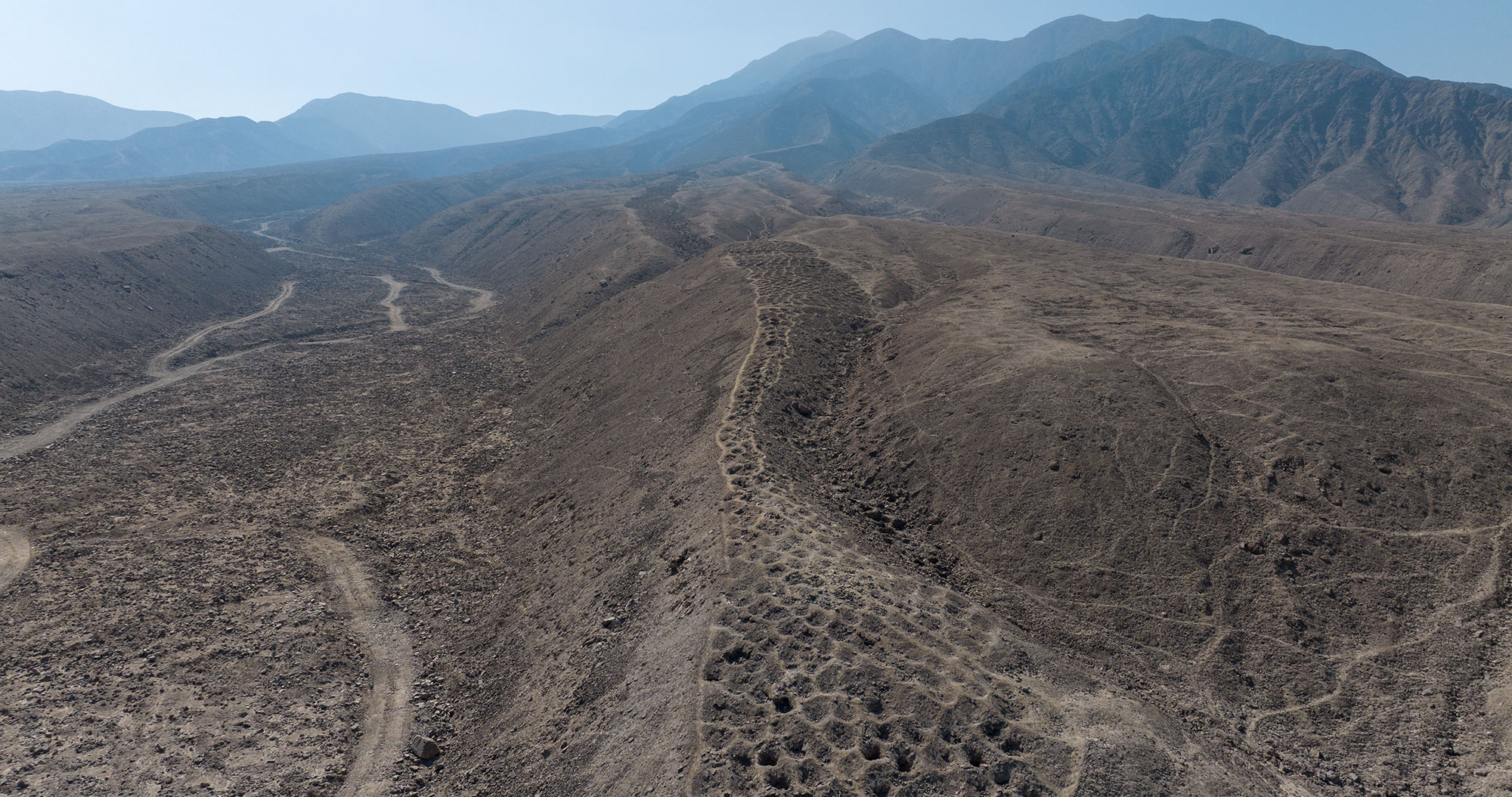Aerial photo of aligned holes on Monte Sierpe, Peru, facing north