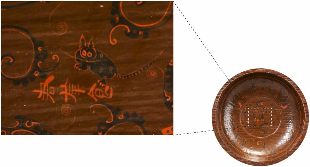 Decorative artifact from the Mawangdui Han Tomb depicting one of the earliest known feline figures, with a spotted coat pattern closely resembling that of a leopard cat
