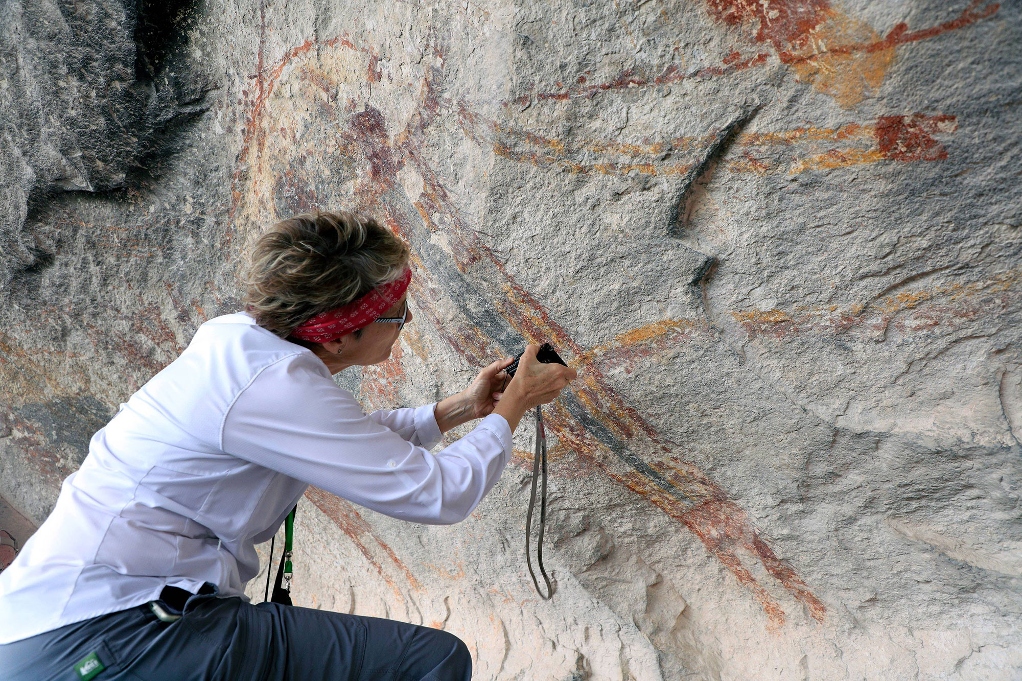 Carolyn Boyd examines the painting sequence of a Pecos River style figure at Fate Bell Shelter in Seminole Canyon State Park and Historic Site.