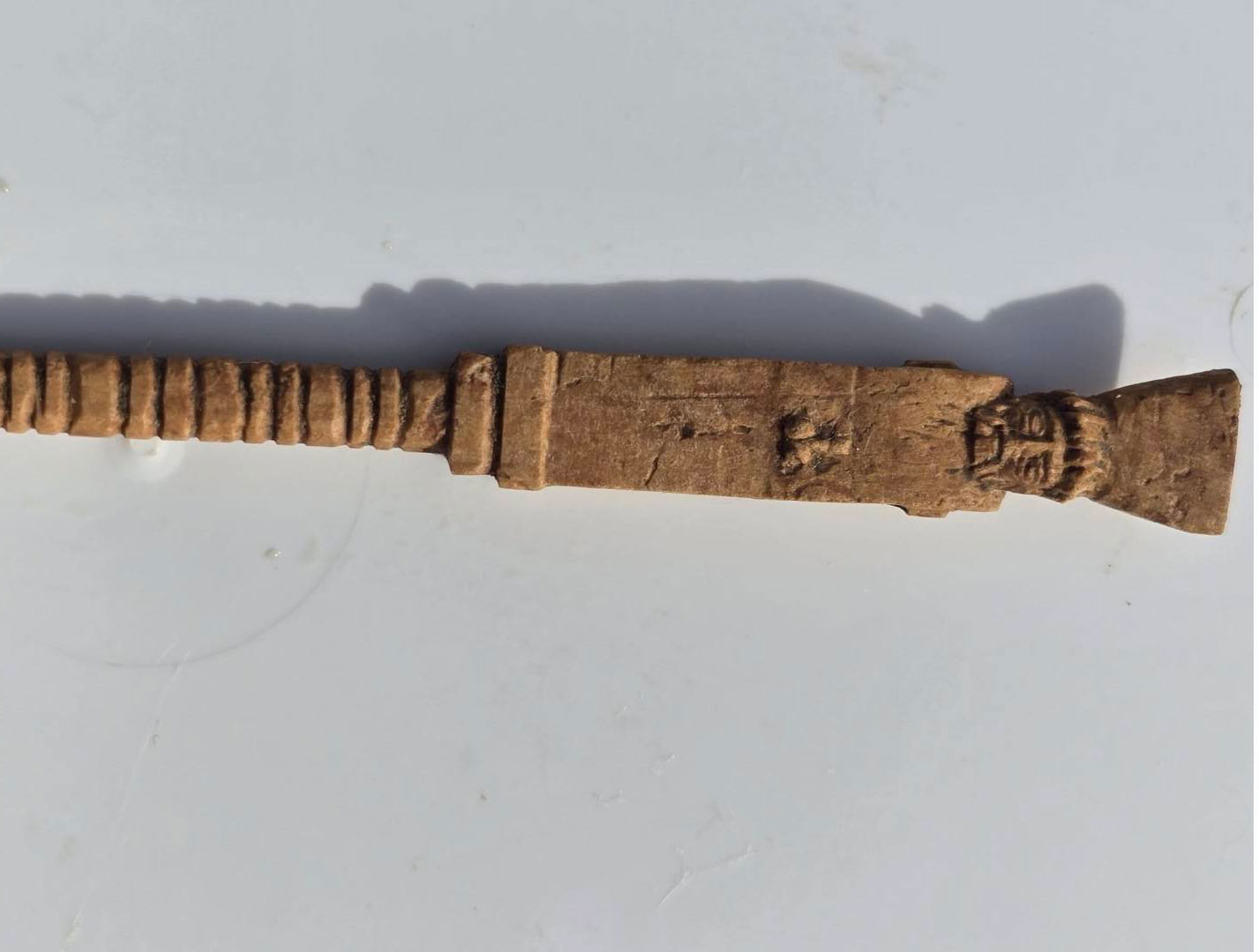 Bone stylus carved with a phallus and head, probably of Dionysus as a herm