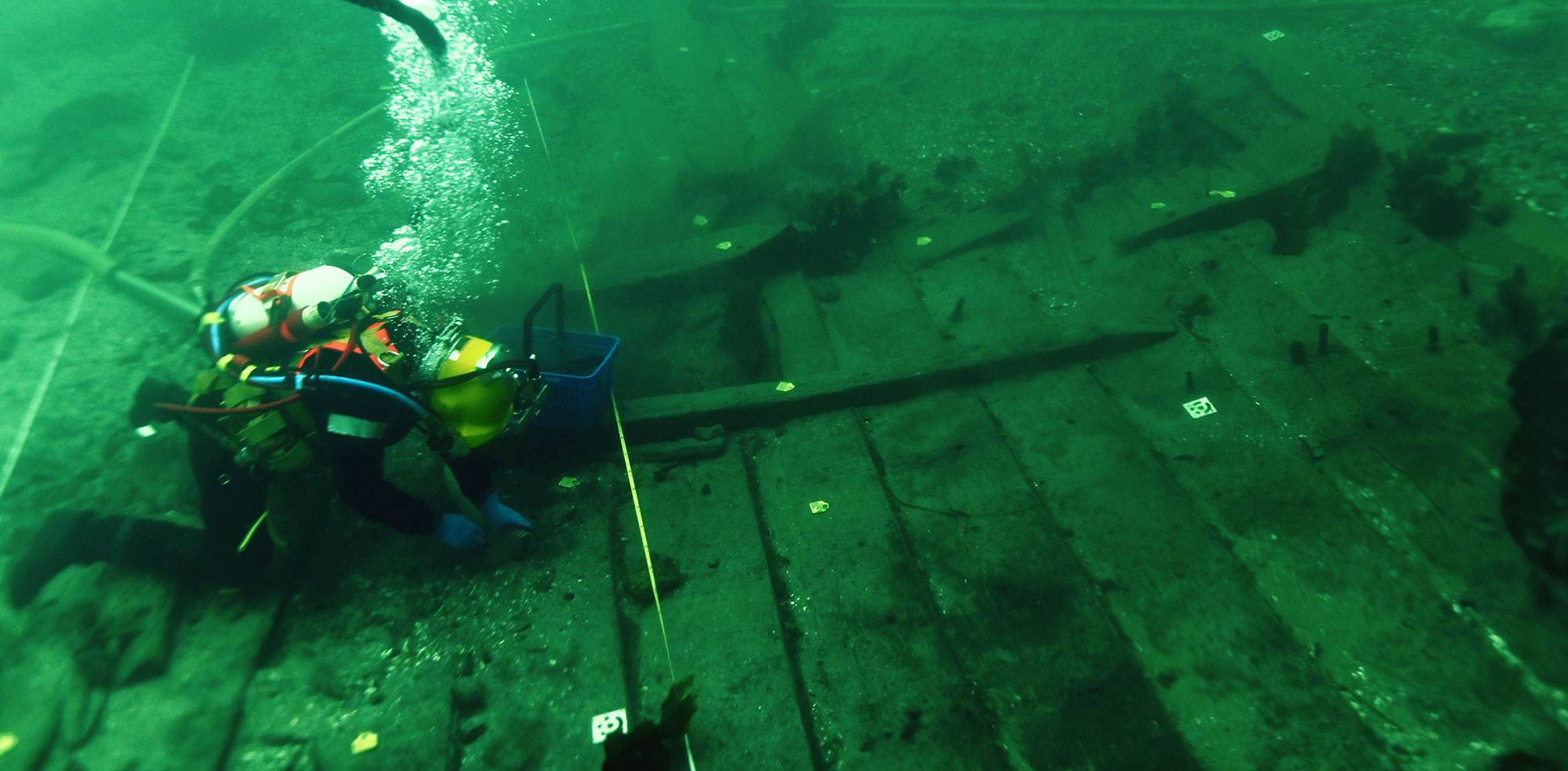 A diver excavates the submerged remnants of a medieval shipwreck on the seafloor off the coast of Copenhagen, Denmark.