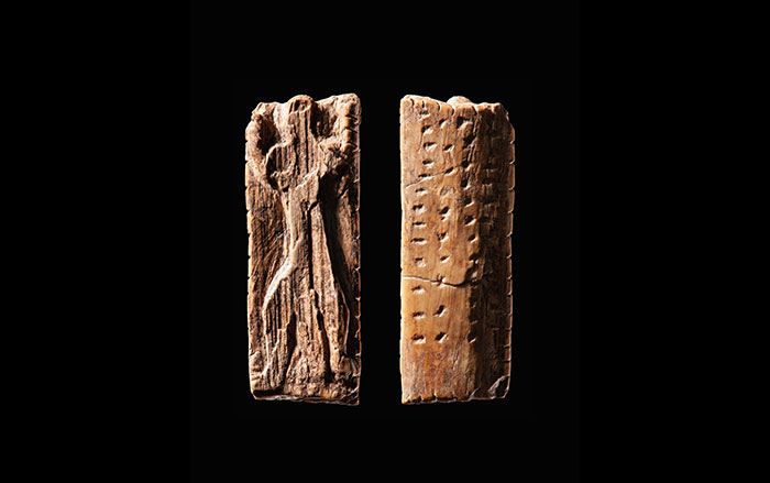 Small ivory figurine incised with dots and notches