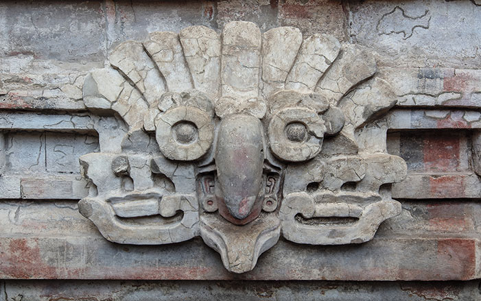 Stucco owl headdress relief