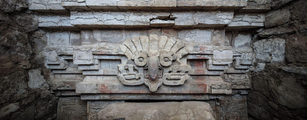 Stucco owl headdress relief