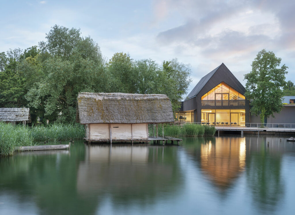 A replica of a small Neolithic pile dwelling stands next to the Pile Dwelling Museum in Unteruhldingen. 
