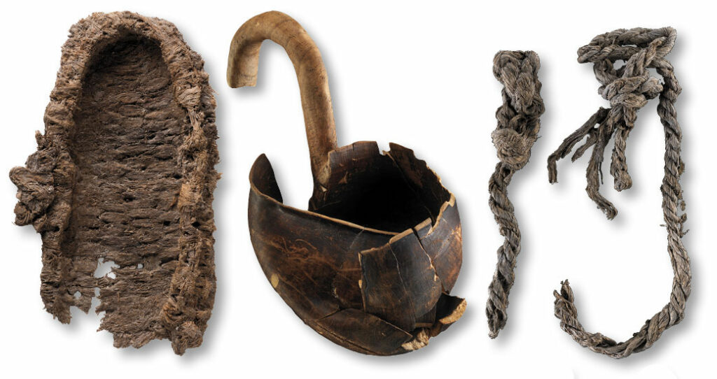 A shoe made from tree fiber, a wooden ladle, and twine.