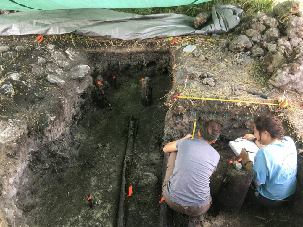 Archaeologist Lara S&aacute;nchez-Morales (left) documents excavation of a trench that yielded preserved Maya wooden architecture.