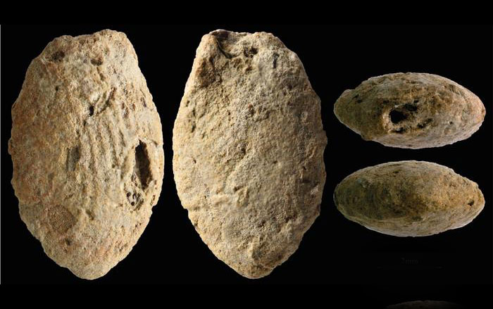 Natufian butterfly clay bead, colored red with ocher and marked with the fingerprints of the child who modeled it 12,000 years ago