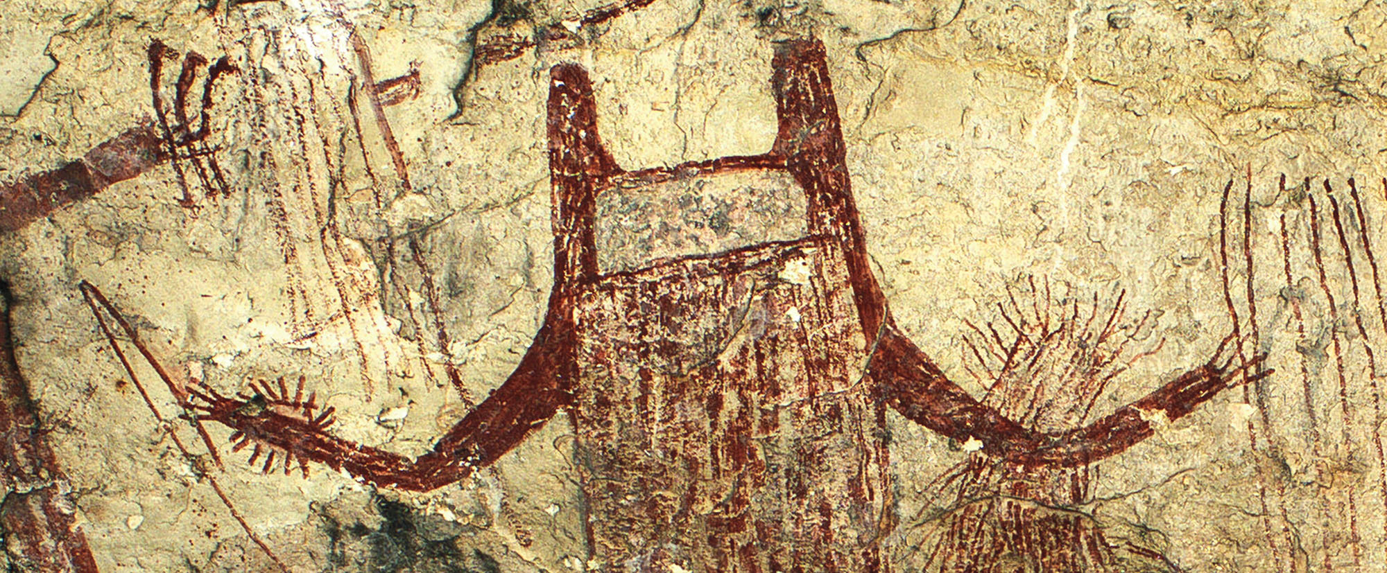 A 13-foot-tall red human-like figure with a U-shaped head looms over several other Pecos River Style images