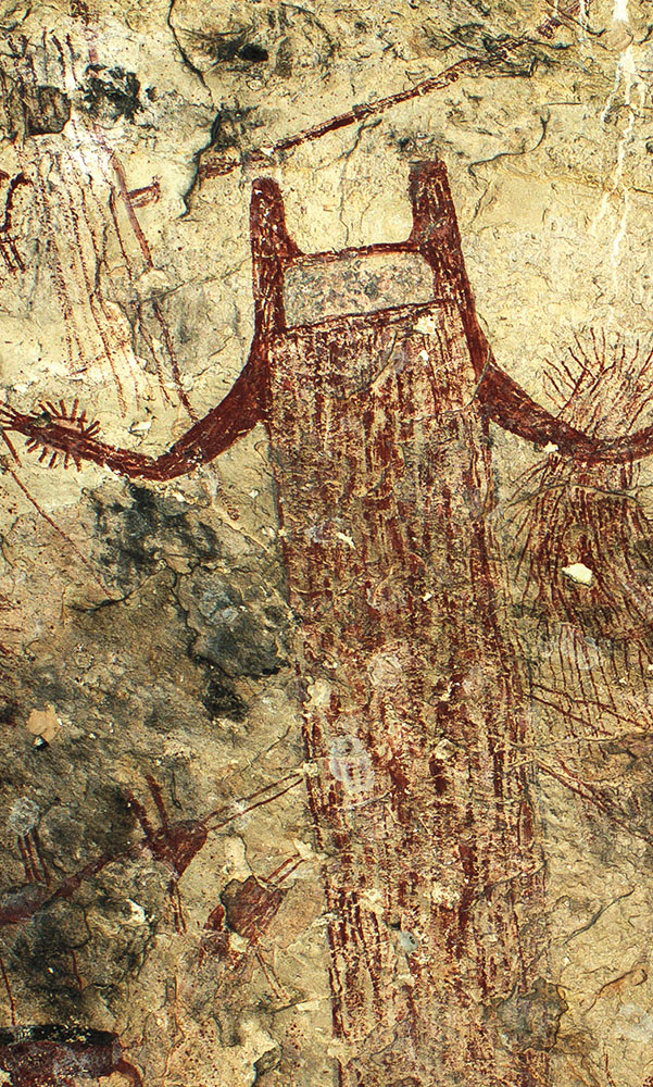 A 13-foot-tall red human-like figure with a U-shaped head looms over several other Pecos River Style images
