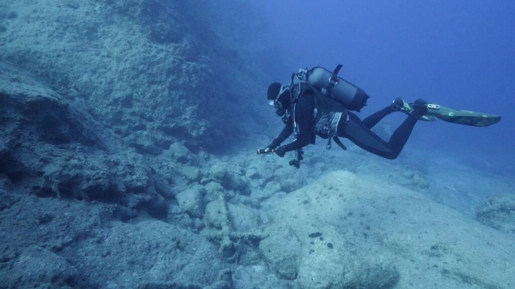 A diver records Byzantine anchors on the seafloor off the coast of Karpathos, Greece.
