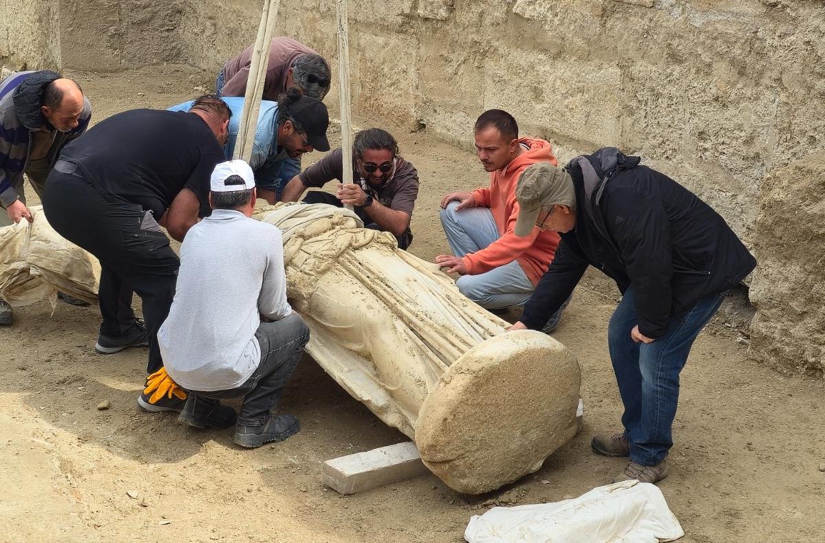 Archaeologists lift a marble statue of Athena excavated at Laodicea, Turkey