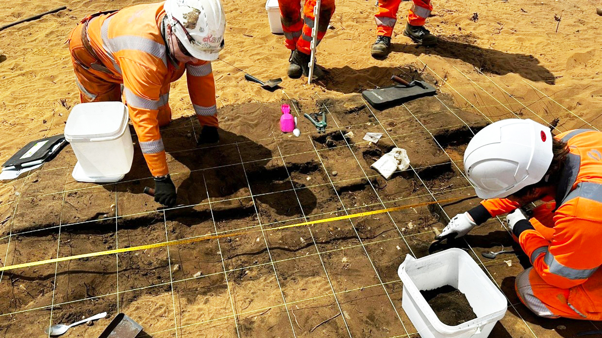 Archaeologists excavate a cremation pyre at the Sizewell C site, Suffolk, England.